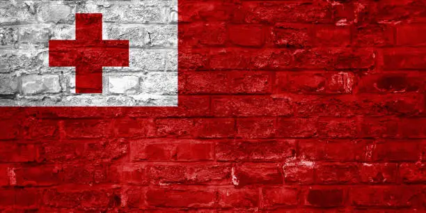 Photo of Flag of Tonga over an old brick wall background, surface