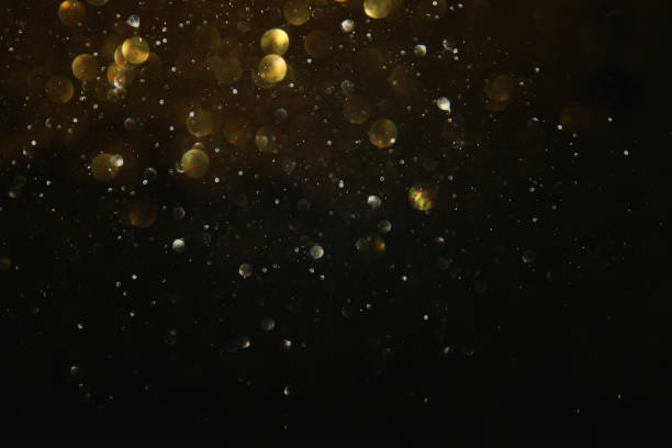 istock glitter vintage lights background. black and gold. de-focused. 1029391532