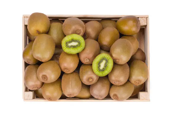 Photo of Wooden Box filled with many ripe Kiwi fruits