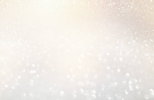 istock glitter vintage lights background. silver, gold and white. de-focused. 1029391572