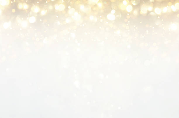 istock glitter vintage lights background. silver, gold and white. de-focused. 1029392222