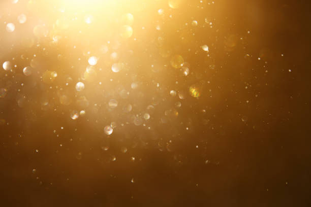 istock glitter vintage lights background. black and gold. de-focused. 1029392250