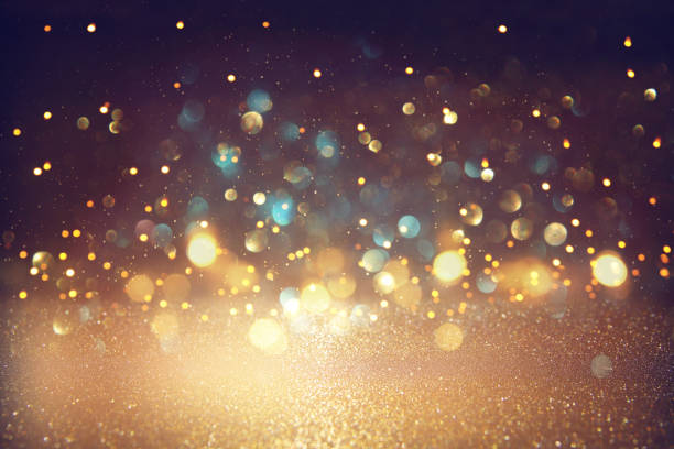 istock glitter vintage lights background. black, blue and gold. de-focused. 1029392258