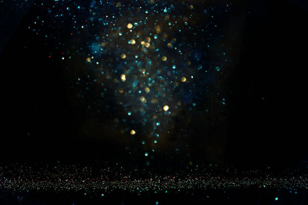 istock glitter vintage lights background. black, blue and gold. de-focused. 1029392270