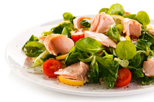 istock Vegetable salad with salmon on white background 1029392412