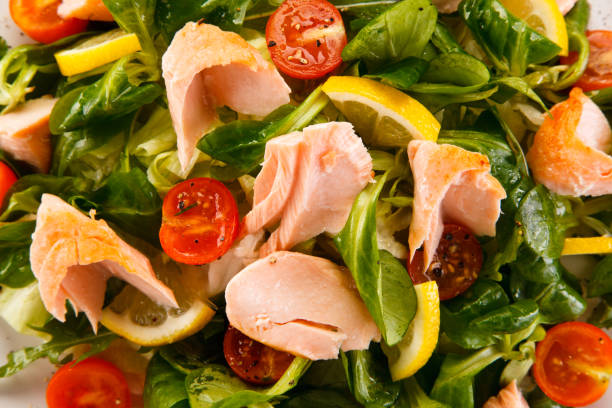 istock Vegetable salad with salmon on white background 1029396620