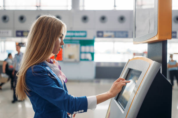 istock Stewardess uses terminal at the airport hall 1029397280
