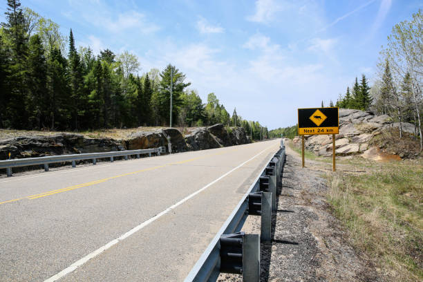 アルゴンキン州立公園道路 - moose crossing sign ストックフォトと画像