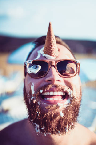 istock Handsome Bearded Male Playing With Ice Cream 1029424670