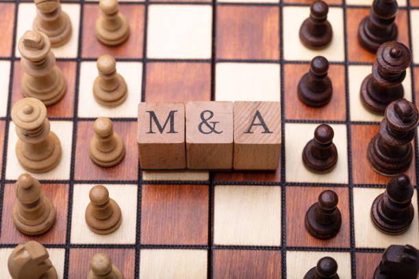 istock Wooden Blocks With Mergers And Acquisitions Text On Chess Board 1029427622
