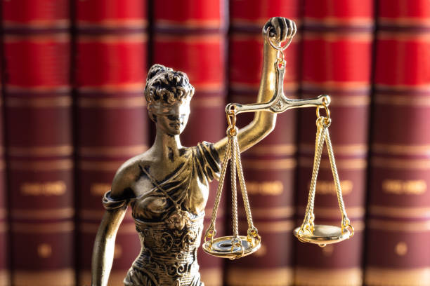 istock Justice Statue In Front Of Red Law Books 1029427662