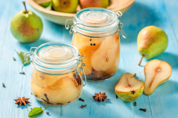 istock Sweet and tasty pickled pears on blue table 1029427670