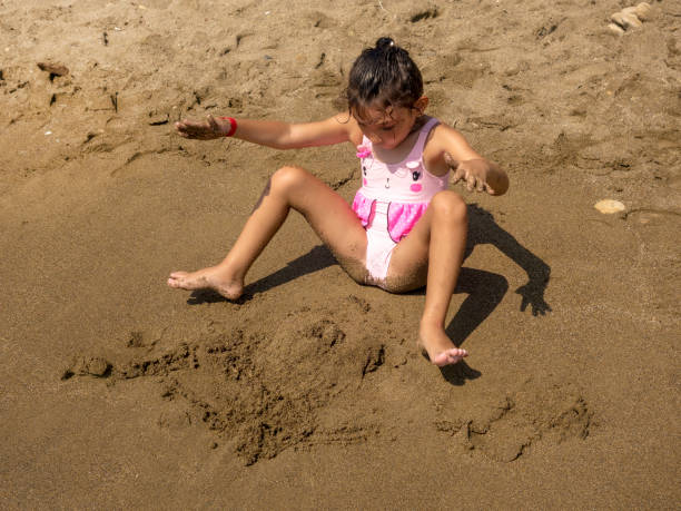 girl playing in sand-littlegirl playing in sand-little