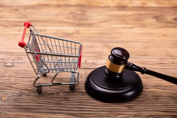 Photo of Judge Gavel And Shopping Cart On Table