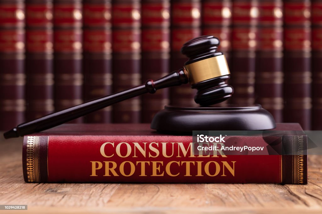 Wooden Gavel And Soundboard On Consumer Protection Law Book Gavel And Soundboard On Consumer Protection Law Book Over Wooden Table Consumerism Stock Photo