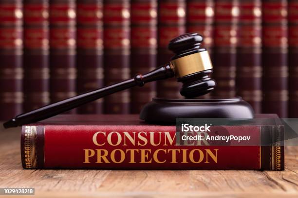 Wooden Gavel And Soundboard On Consumer Protection Law Book Stock Photo - Download Image Now