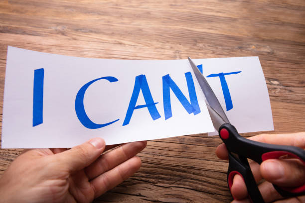 istock Person's Hand Cutting Paper Word I Can't 1029428324