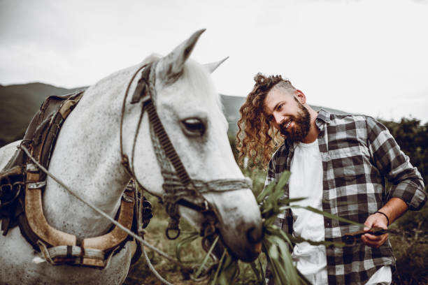 istock Handsome Male Feeding His Favorite Horse 1029431650