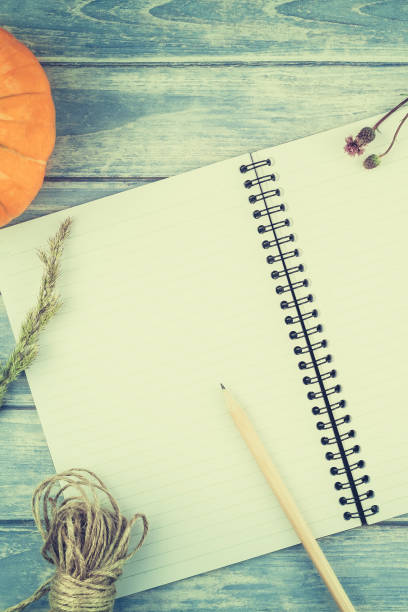 istock Blank notebook with pencil and autumn pumpkins 1029441190