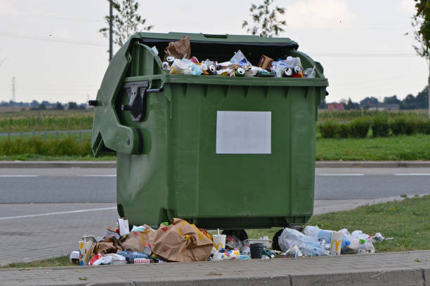 Overflowing rubbish container on the street Gdansk, Poland - 4th August, 2018: Overflowing green rubbish container with empty drinks packages and food wrappers on the public parking. overflowing trash dumpster stock pictures, royalty-free photos & images