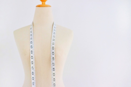 mannequin for designer clothes. fashion design model and measure cable on white background.