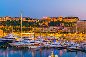 Old town of Monaco overlooking port Hercule during sunset