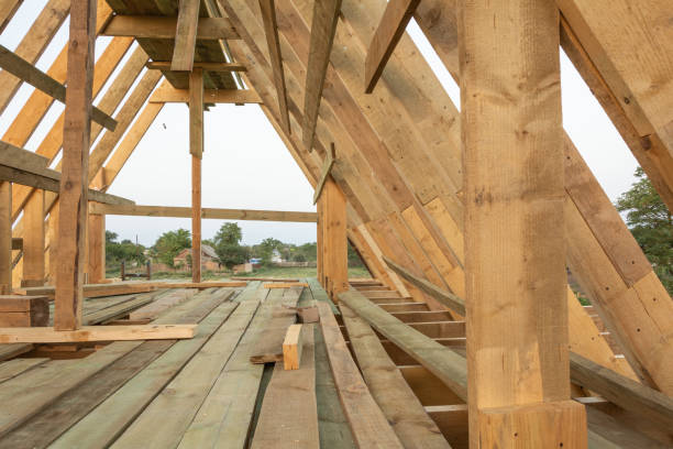 istock Roof frame structure in wood frame home under construction at sunset 1029452128