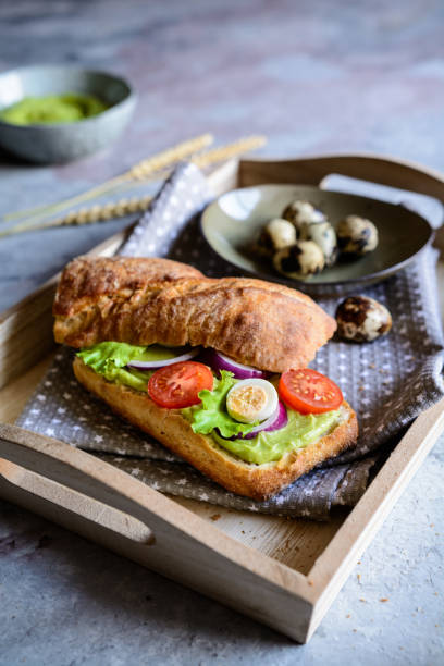 istock Focaccia baguette with avocado spread, lettuce, tomato, onion and quail eggs 1029460968