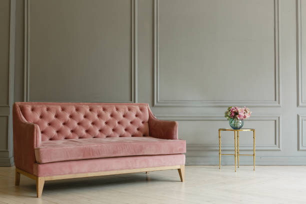 istock Pink sofa on the grey wall background. Minimalism interior 1029463662