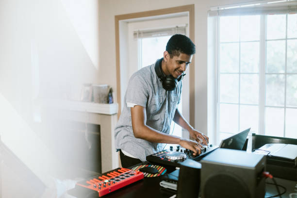 istock Young Adult Man Practicing His Live DJ Set at Home 1029463950