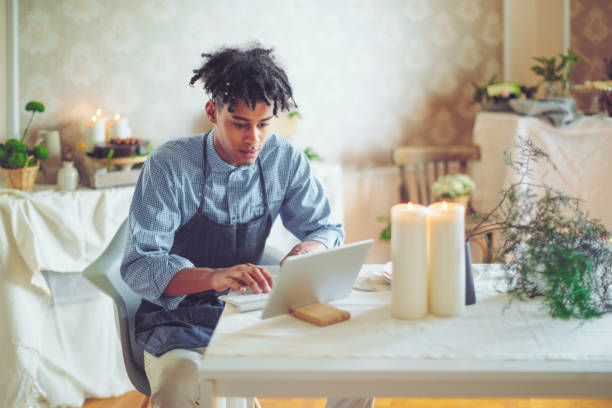Hipster entrepreneur is communicating with his clients online