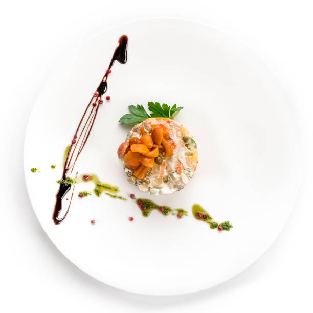 istock Olivier with mushrooms in a white plate, isolated on a white background. View from above, apartment. 1029467160