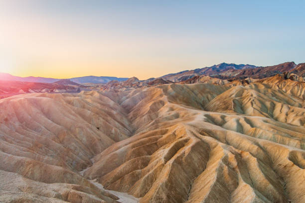 Zabriskie Point badlands at sunrise, Death Valley Beautiful landscape of mudstone badlands at Zabriskie Point at sunrise in summer, Death Valley National Park, California, USA. death valley desert photos stock pictures, royalty-free photos & images
