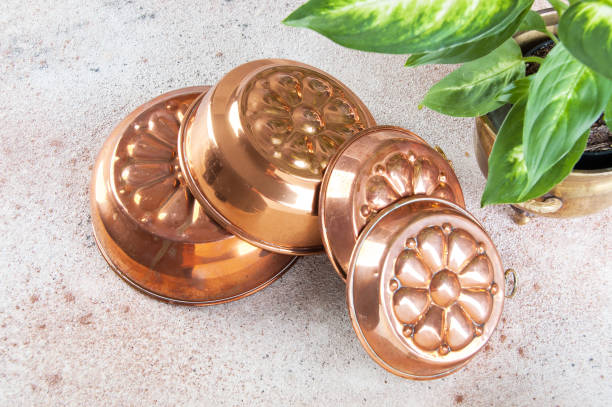 istock Vintage copper molds on a concrete background. 1029479362