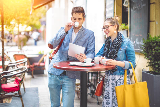 istock Friends are sharing a tablet in a sidewalk cafe 1029481760