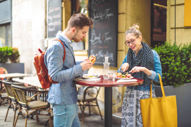 Friends are having lunch in a sidewalk cafe