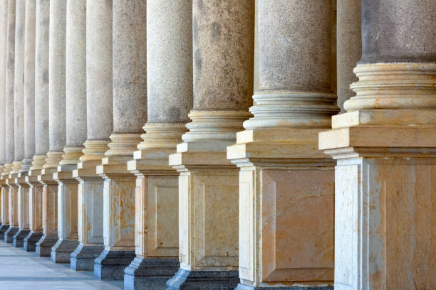 istock Colonnade, row of classical stone columns, background with copy spaced 1029485196