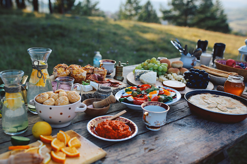 Food for picnic day in the countryside. Various foods on an old, rustic, wooden table.
