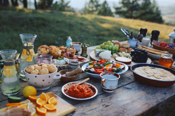 High angle image of a rustic, wooden food table Food for picnic day in the countryside. Various foods on an old, rustic, wooden table. mediterranean culture stock pictures, royalty-free photos & images