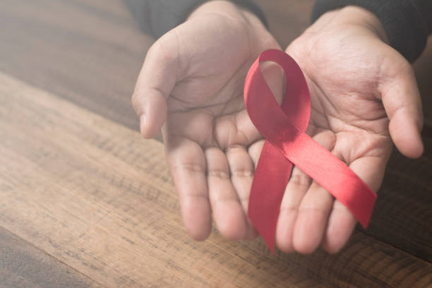 istock Cropped Hands Holding Aids Awareness Ribbon 1029501082