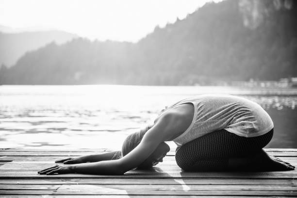 istock Side View Of Woman Exercising On Floorboard At Beach 1029514236