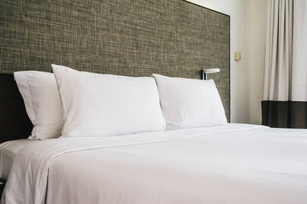 istock White Bed With Pillows In Bedroom 1029524158