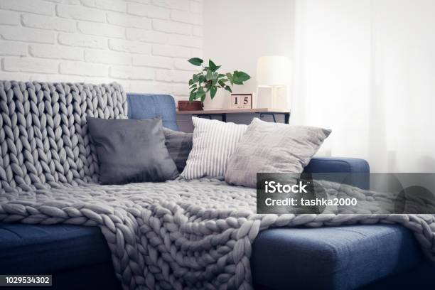 Gray Knitted Blanket From Merino Wool Stock Photo - Download Image Now - Sofa, Blanket, Domestic Life