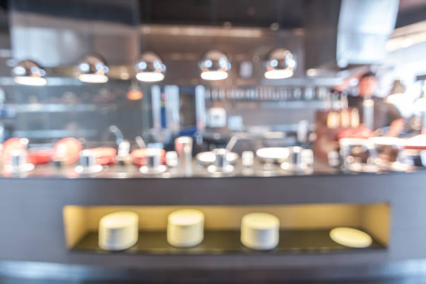istock Buffet at hotel restaurant interior blur background with blurry open kitchen counter bar of food catering service business with chef staff cooking for breakfast, lunch or dinner meal 1029549698