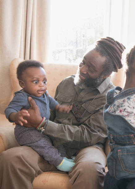 istock Cute baby boy sitting on grandfather's lap 1029554674
