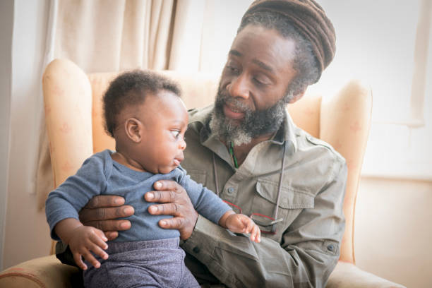 istock Grandfather with baby boy sitting on his lap 1029554678