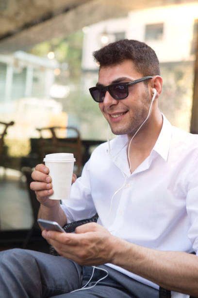 istock Young Businessman with Smartphone in Coffee Shop 1029554810