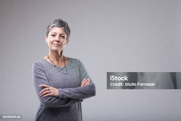 Confident Businesswoman With Folded Arms Stock Photo - Download Image Now - Women, Portrait, One Woman Only