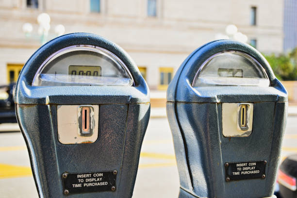 istock 2 Parking Meters with a blurred street background 1029570802