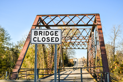 Bridge closed sign at the entrance of an old bridge